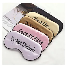 Detail view of smooth silk sleep masks featuring stylish embroidery, soft texture and comfort.