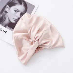 Pink satin sleep cap hair bonnet for women, breathable double layer twist design for night hair.