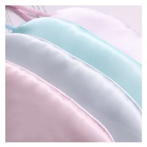 Close up of soft satin sleep masks detail, pastel colors, comfortable shading blindfold.