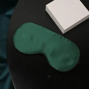 Maschera da notte in seta verde scuro con bordo nero e cinturino regolabile per sonno.