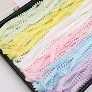 Close up detail of colorful pom-pom fringe trim, soft mini tassel lace for DIY sewing.