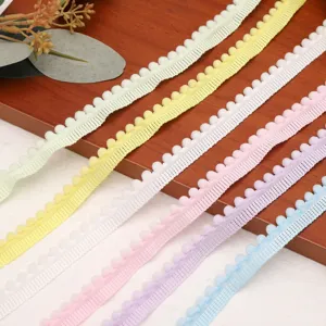 Colorful pom pom fringe trim detail shot, pastel fabric ribbon for DIY sewing crafts