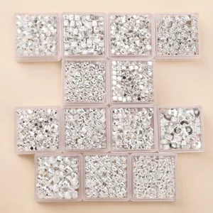 Close-up of various silver alloy spacer beads in clear boxes, perfect for DIY jewelry making.