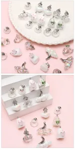 Close-up details of assorted cute ghost resin and alloy DIY charms for handmade crafts.