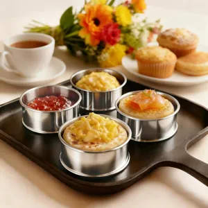 Detailed view of stainless steel mousse ring and tart mold used for baking delicious treats.