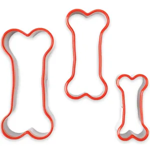 Close-up detail of 3-piece red dog bone cookie cutters, soft PVC DIY puppy snack molds.