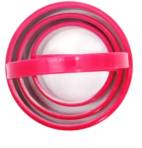 Detailed view of pink nested round baking molds with a convenient plastic handle set.