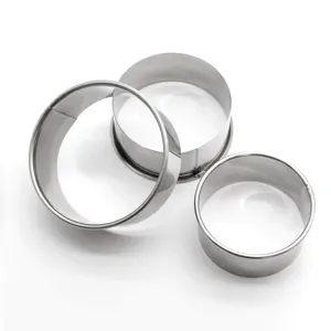 Closeup view of stainless steel dumpling wrapper mold set, kitchen baking pastry cutting tools.