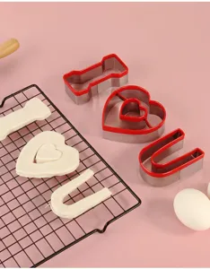Stainless steel cookie cutter set with red PVC edge, heart and letter shapes for DIY baking.