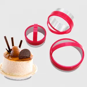 Stainless steel mousse cake molds set with red plastic handles for baking round cookies desserts.