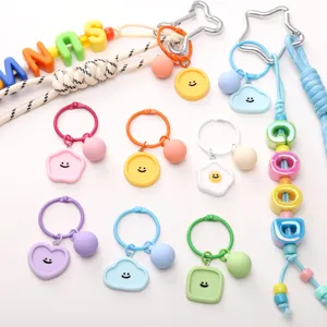 Nahaufnahme Detailansicht von bunten Smiley-Harz-Schlüsselanhängern und DIY-Zubehör.