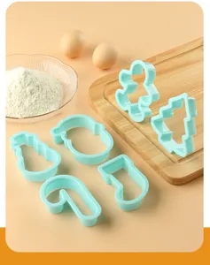 Detailed view of Christmas cookie cutter set, blue plastic molds for baking festive treats.