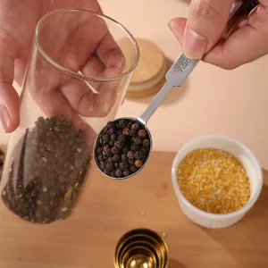 Stainless steel measuring spoon for kitchen baking coffee and seasoning use with clear scale.