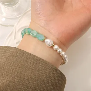 Elegant green crystal and white pearl beaded bracelet, fashion handmade jewelry accessory.