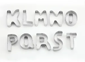 Close-up detail of stainless steel letter cookie cutters K to T, perfect for baking.