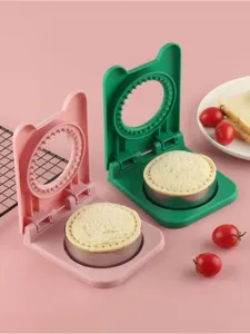 Close up detail of plastic sandwich cutter and sealer mold with cute cat ear handles for toast.