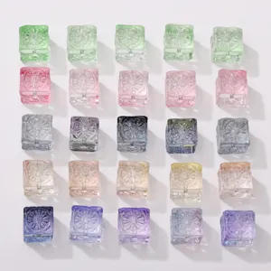 Close-up detail of colorful transparent square glass beads with crackled floral texture.
