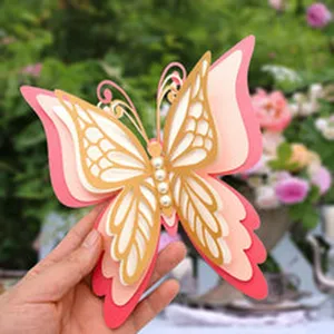 Detailed view of 3D layered paper butterfly decoration with pearl accents for home crafts.
