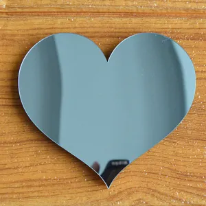 Dettaglio specchio acrilico a forma di cuore, superficie liscia e stile decorativo casa.