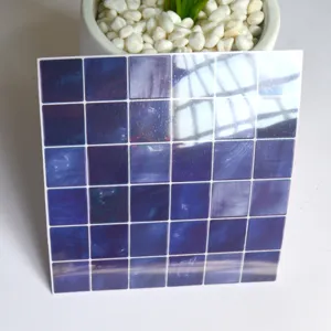 Detailed shot of dark blue mosaic tile sticker, glossy finish, self-adhesive wall decor.