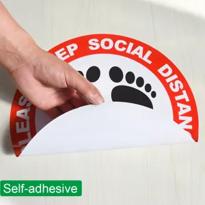 Floor sticker detail showing self-adhesive backing and clear social distance warning print.
