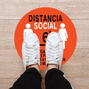 Social distance warning floor sticker, round orange sign for public safety control.