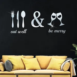 Detail shot of acrylic mirror wall sticker featuring utensils and eat well quote for kitchen decor.