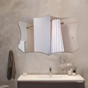 Modern irregular wall mirror detail showcasing unique scalloped wave edge design in bathroom.