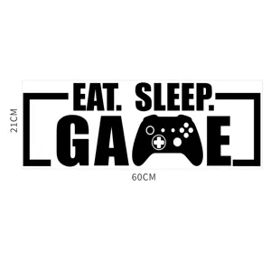 Close up view of acrylic mirror wall sticker showing game controller design and slogan text.
