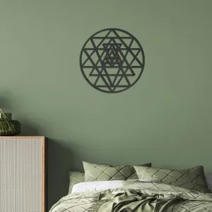 Sacred geometry wall sticker detail showing the intricate circular pattern mounted on a green wall.