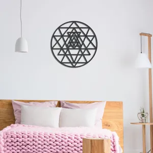 Detail view of the black geometric wall sticker displayed in a cozy bedroom interior.