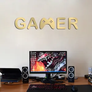 Acrylic gamer wall sticker with gamepad design, gold mirror finish for living room decor.
