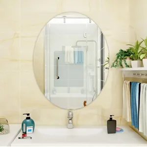 Detail shot of an elegant oval wall mirror perfectly mounted in a modern bathroom interior setup.