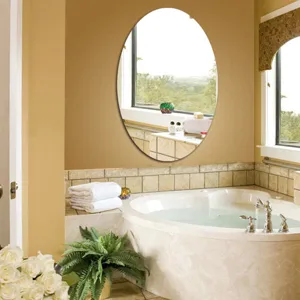 Detail view of an elegant oval wall mirror installed in a modern cozy bathroom decor setting.