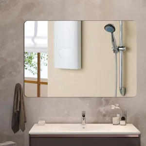 Bathroom wall mirror detail showing clear reflection, modern minimalist rounded rectangle style.