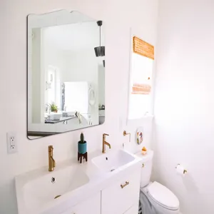 Modern decorative wall mirror with unique curved top for bathroom and vanity decoration