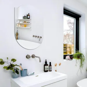 Modern minimalist oval wall mirror for bathroom decoration, sleek frameless design for home.