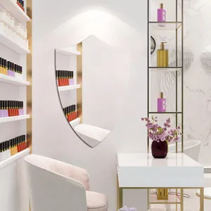 Detailed view of shield shaped decorative wall mirror in modern salon interior setup.