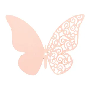 Close-up detail of the pink pearlescent paper butterfly, featuring a delicate hollow swirl design.