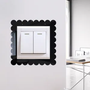 Black acrylic mirror switch sticker with scalloped border for elegant home wall decoration.