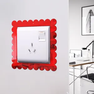 Detailed view of red acrylic mirror switch sticker, decorative wall plate surround.