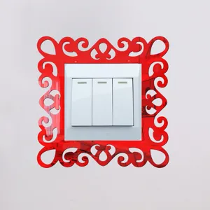 Close-up detail shot of red acrylic mirror switch sticker with hollow-out decorative frame.