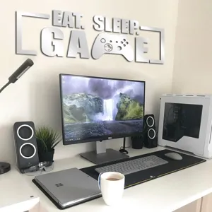 Detail view of acrylic mirror wall sticker featuring eat sleep game text for stylish room decor.