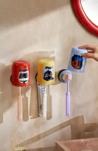 Detail view of colorful wall-mounted suction toothbrush holder set with inverted cups for bathroom.