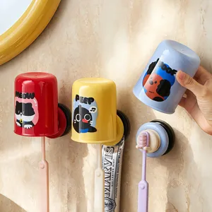 Wall-mounted suction toothbrush holder set with inverted cups for bathroom organization.