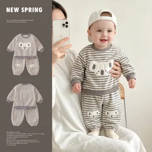 Detailed view of baby boys grey striped sweatshirt and pants set with cute koala patch
