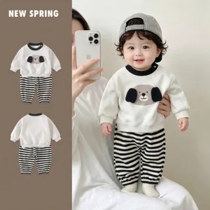 Close-up of baby boy striped romper set with cartoon dog applique for spring