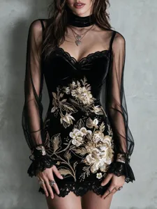Close-up detail of black velvet mini dress with gold floral embroidery and mesh sleeves