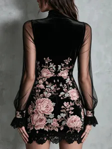 Close-up of black velvet dress with elegant pink floral embroidery and lace trim