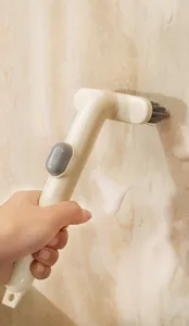 Spazzola di pulizia multifunzionale con serbatoio per la pulizia delle fughe di cucina.